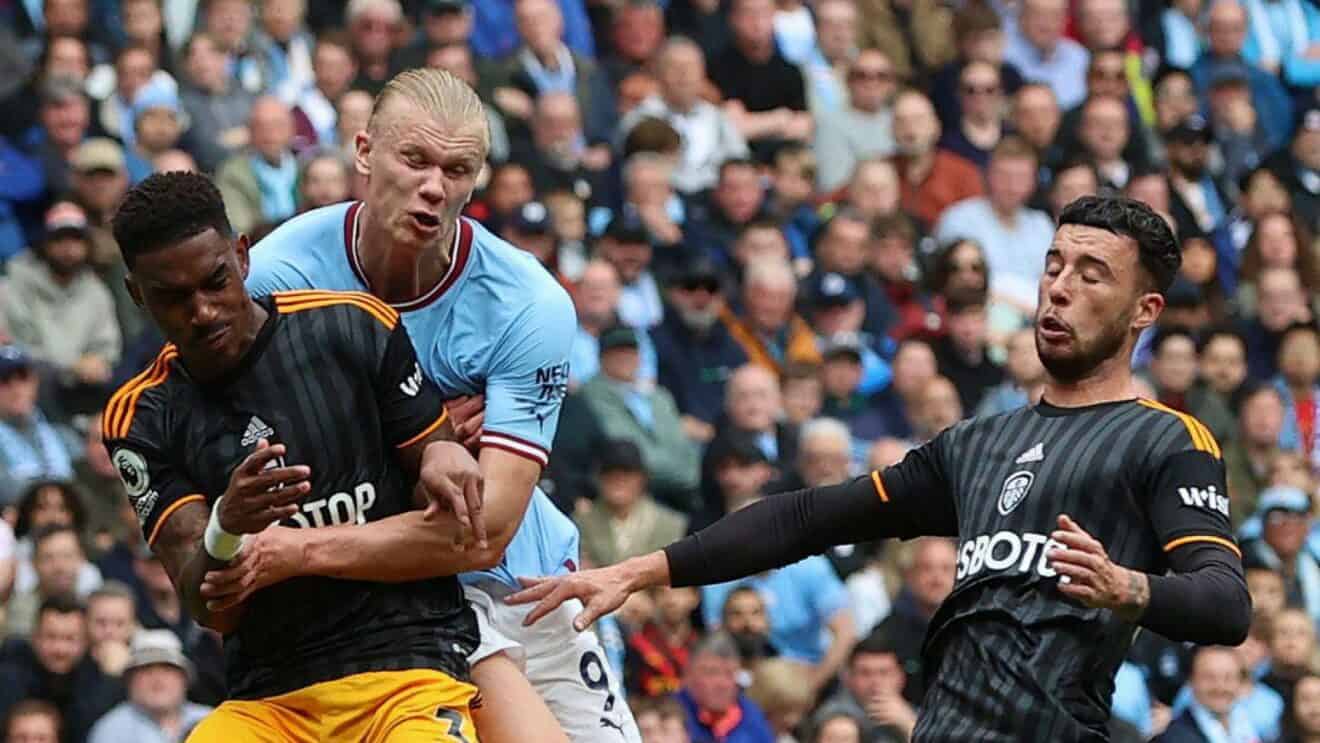 Not quite galactic giants colliding, but it is Erling Haaland being banged into by Junior Firpo and Sam Greenwood