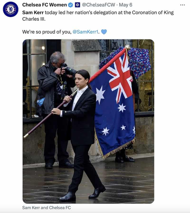 A tweet by Chelsea FC Women with a photo of Sam Kerr representing Australia at the coronation of King Charles III by carrying big flag and wearing some shiny shoes.